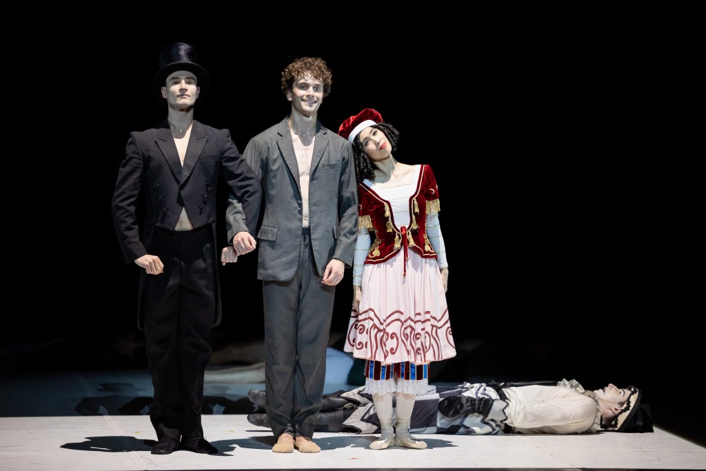 Callum Linnane as Vaslav Nijinsky, Ako Kondo as Tamara Karsavina, Maxim Zenin as Serge Diaghilev, and Brodie James as Petruschka in The Australian Ballet's 2025 production of Nijinsky, choreographed by John Neumeier. The dancers are captured in a dynamic tableau, reflecting the intricate relationships and emotional intensity central to Nijinsky's life and career.