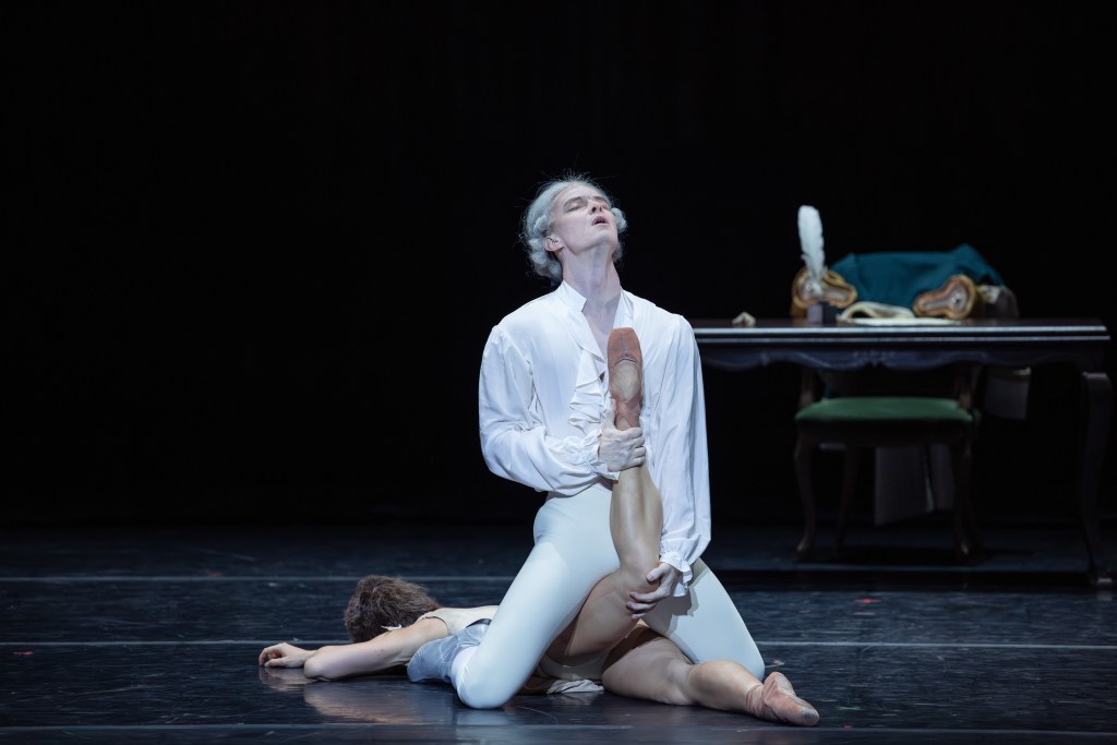 Jarryd Madden as the Gaoler and Benedicte Bemet as Manon in The Australian Ballet's 2025 production of Manon. Captured in a poignant moment, Madden's portrayal of the authoritative figure contrasts with Bemet's delicate and expressive performance, highlighting the emotional tension in this pivotal scene.