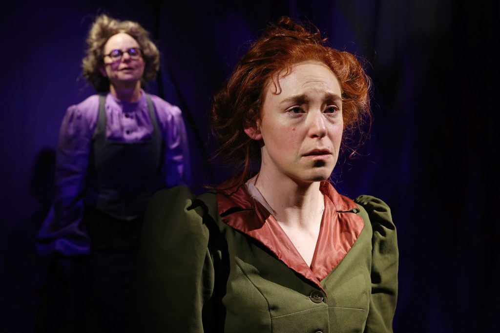 Marie Curie stands in a green dress with blackened hands, symbolizing the physical toll of her scientific work with radioactive elements.